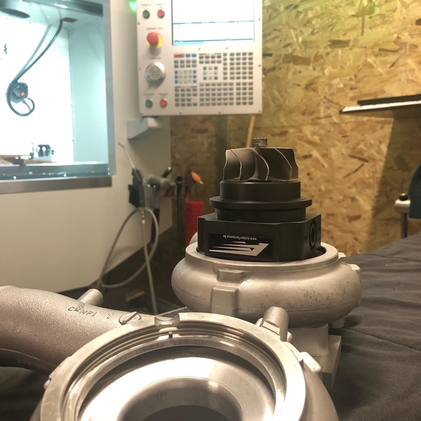 Engine component being machined and measured with a digital caliper